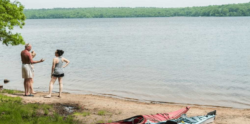 Kayaks on the shore of Watchaug Pond