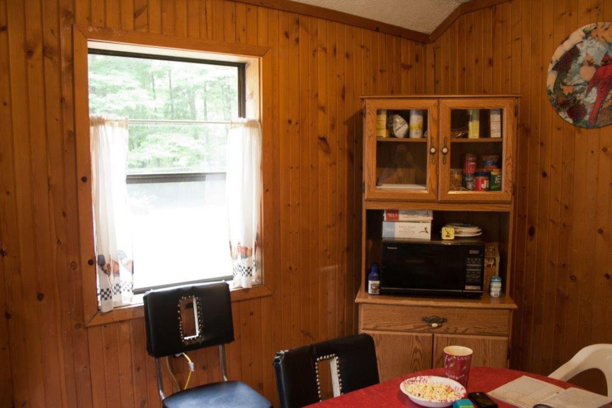 Pine-paneled cabin interior with kitchen hutch