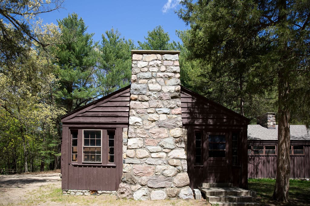 CCC-built cabin with a fieldstone chimney among the pines